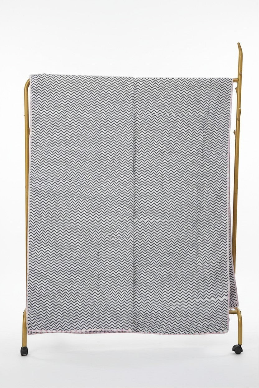 nindhaara.com Bagh-E-Savera reversible mulmul cotton dohar with black and white chevron print on a gold rack