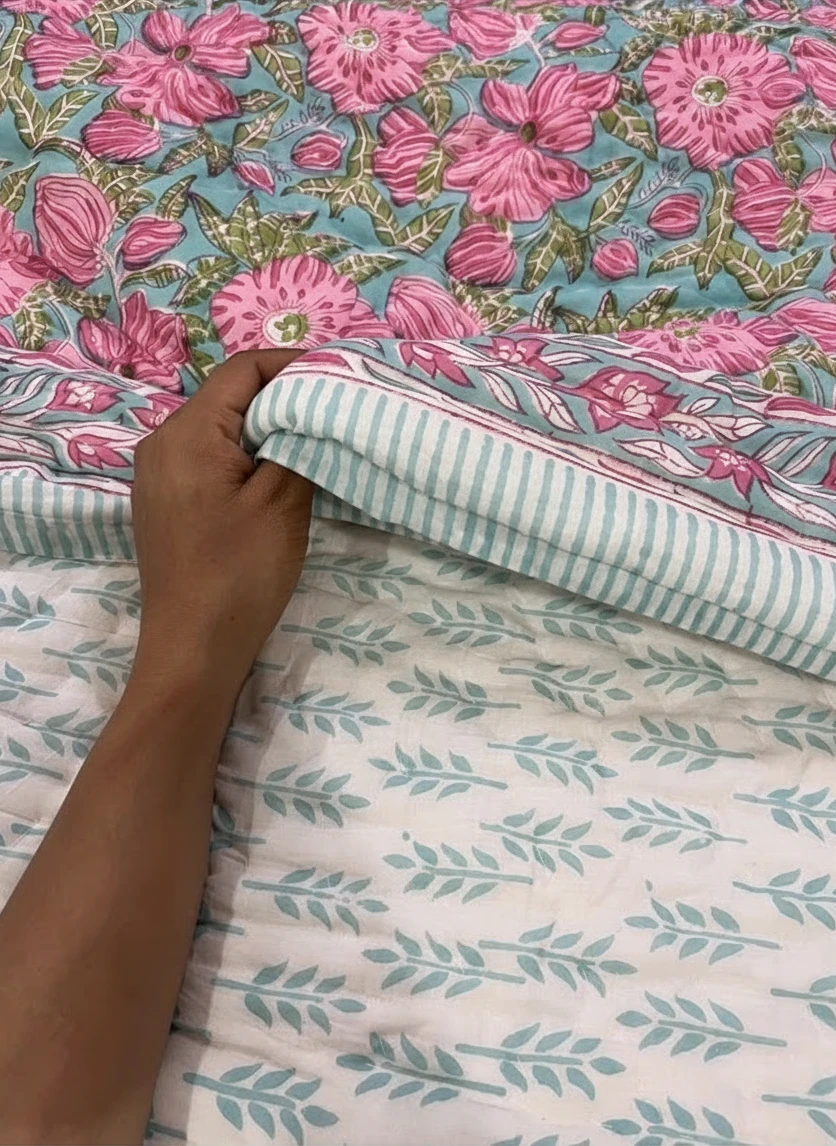 nindhaara.com hand-quilted reversible mulmul cotton razai with pink floral print and mint aqua sprig reverse